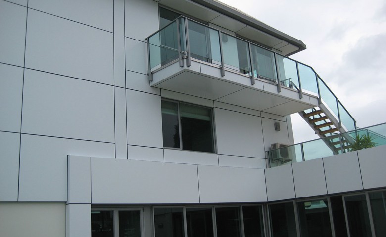 Glass balcony on white tiled cutterscove building project managed by IPMS